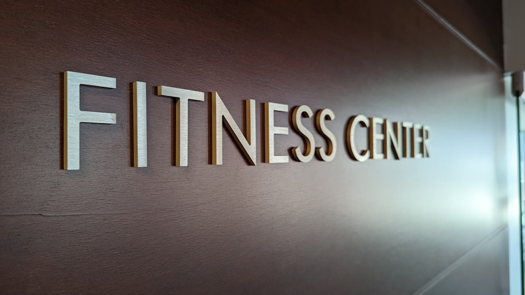 a-sign-that-says-fitness-center-on-a-wall-xfybyj26wik