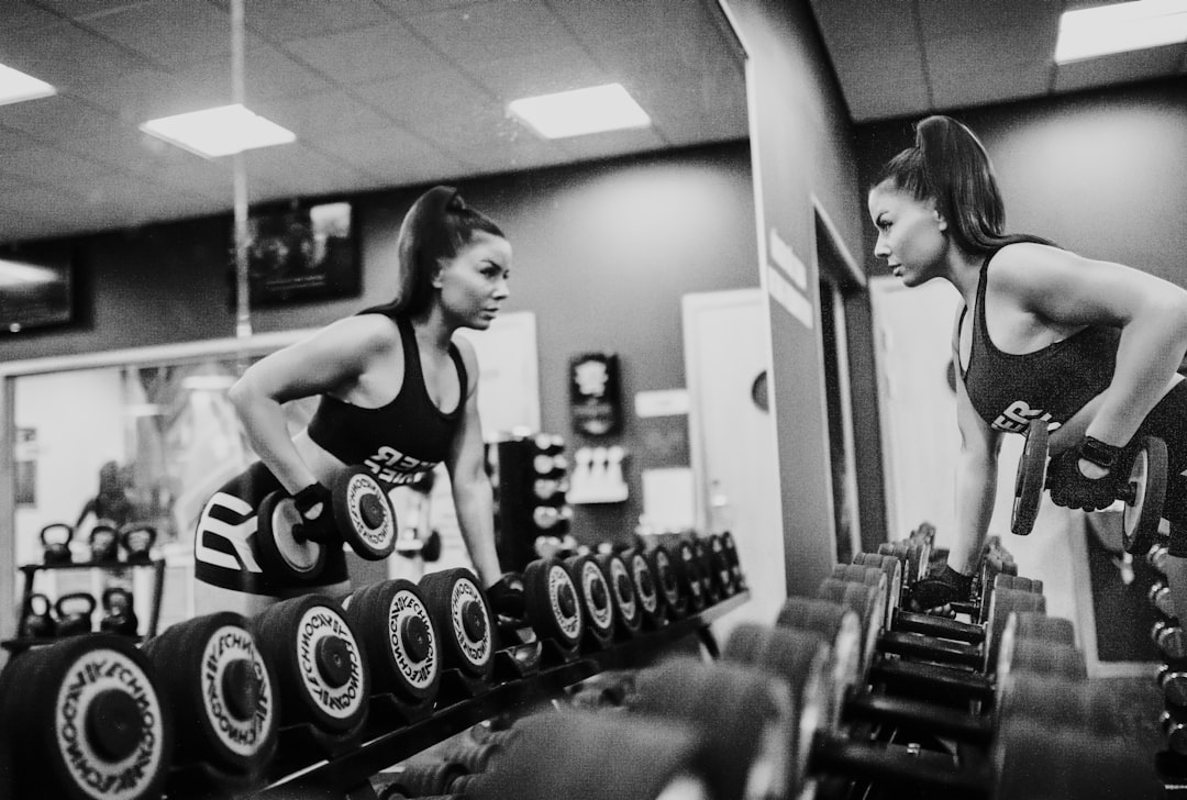 woman-in-black-tank-top-and-black-shorts-doing-exercise-l9z19qt576c